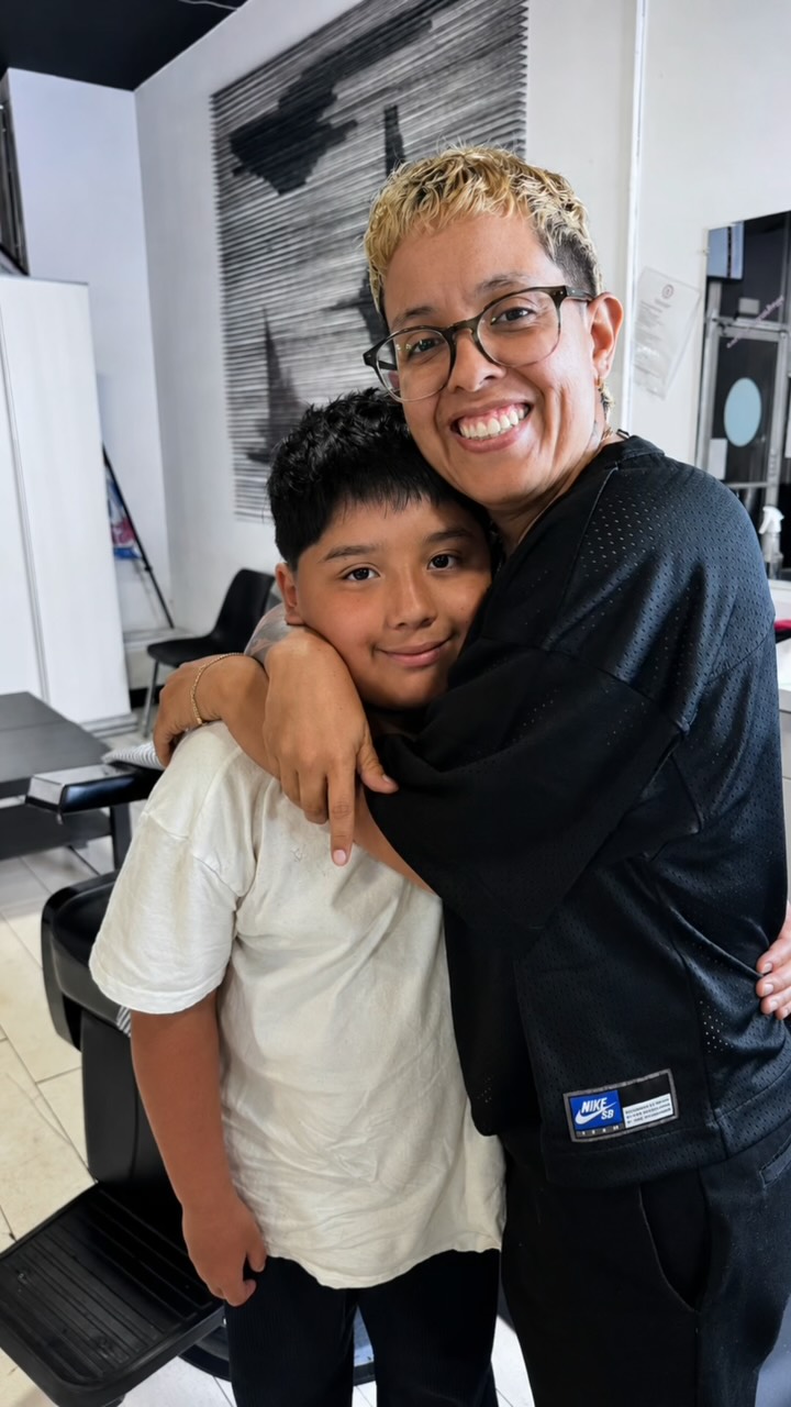 Preview of the H.E.R. Future Instagram reel: a student embracing a client behind the chair