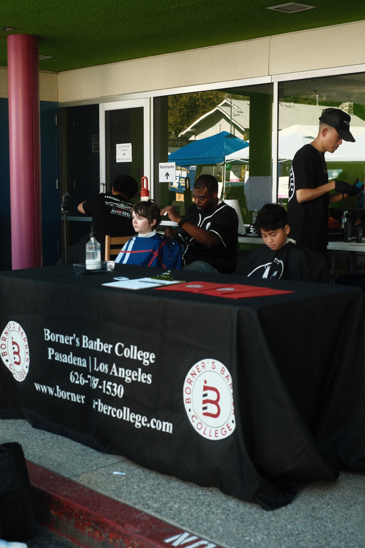 Borner's Barber College table at a community cut day